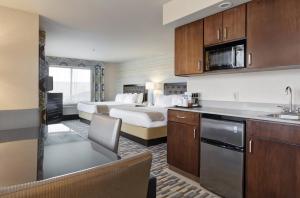 a hotel room with two beds and a kitchen at Holiday Inn Express Hotel & Suites Warwick-Providence Airport, an IHG Hotel in Warwick