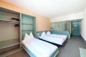 Postel nebo postele na pokoji v ubytování Hotel City am Bahnhof