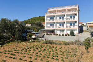 a building with a lot of plants in front of it at Villa San Marco in Tribunj