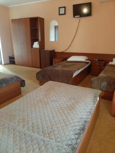 a hotel room with a bed and a desk at Stara Vezha Hotel in Boryspil