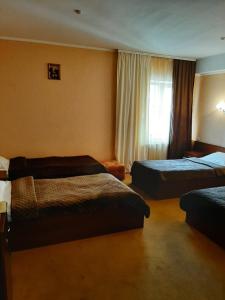 a hotel room with two beds and a window at Stara Vezha Hotel in Boryspil