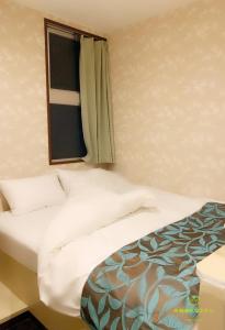 Krevet ili kreveti u jedinici u okviru objekta Nishifunabashi Ekimae Hotel