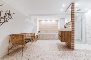 a bathroom with a chair and a sink and a tub at Cozy Pillow in Utrecht