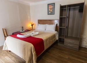 Un pat sau paturi într-o cameră la Askha Cusco