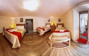 Un pat sau paturi într-o cameră la Askha Cusco