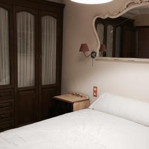 una camera con un letto e un grande specchio di La casita de la dormilona ad Algimia de Almonacid