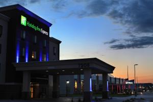 a building with a sign on the top of it at Holiday Inn Express & Suites Omaha South Ralston Arena, an IHG Hotel in Omaha