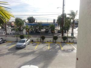 a parking lot with a car parked in it at Motel 6 Bell Gardens in Bell Gardens