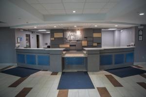 a large lobby with blue counters in a building at Holiday Inn Express Hotel & Suites Erie - North East, an IHG Hotel in North East
