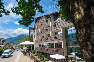 a building on a street with mountains in the background at Villa Adriano in Estosadok