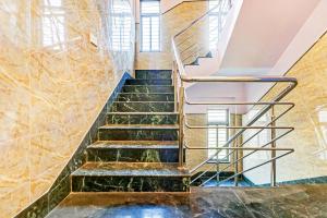 a staircase in a building with green marble at FabHotel Step Inn in Kolkata