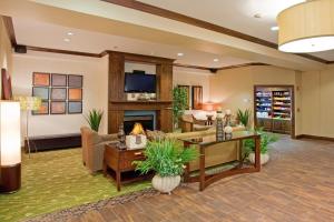 a living room with a couch and a fireplace at Holiday Inn Express & Suites Logan, an IHG Hotel in Logan