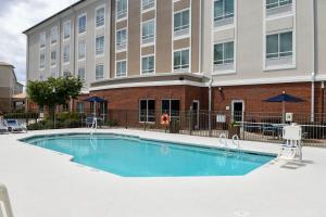 a swimming pool in front of a building at Holiday Inn Express & Suites - Valdosta, an IHG Hotel in Valdosta