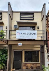 a building with a sign for a carolis place at Carlo'S Place in Dumaguete