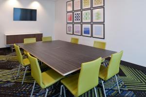 einen Konferenzraum mit einem Holztisch und gelben Stühlen in der Unterkunft Holiday Inn Express & Suites - Ottumwa, an IHG Hotel in Ottumwa