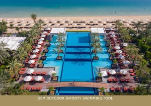 an aerial view of a resort swimming pool and the beach at Jumeirah Zabeel Saray in Dubai