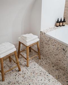 a bathroom with two stools next to a bath tub at Cozy Pillow in Utrecht