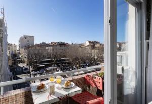 a balcony with a table and a view of a city at CANNES Festival Films Center, with 2 bedrooms and balcony in Cannes +12 photos