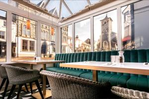 a restaurant with tables and chairs and a clock tower at Skiddaw Hotel in Keswick