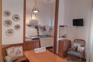 a kitchen with a table and a dining room at Casa Pusterla in Venice