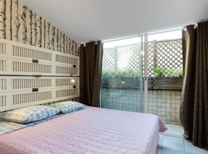 a bedroom with a pink bed and a window at CANNES Festival Films Center, with 2 bedrooms and balcony in Cannes