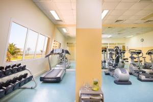 a gym with treadmills and elliptical machines at Masira Island Resort in Ḩilf