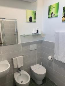 a bathroom with a white toilet and a sink at B&B Ladidi in Rapallo