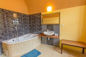 a bathroom with a tub and a sink at Ubytování 8 in Jaroměř