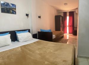Postel nebo postele na pokoji v ubytování Hotel Métropole Résidence