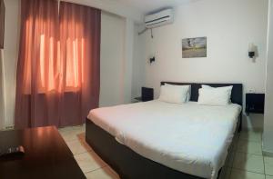 Postel nebo postele na pokoji v ubytování Hotel Métropole Résidence