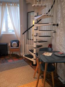 a dining room with a table and a spiral staircase at Heritage City - The Auld Pottery in Edinburgh