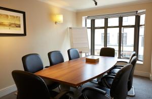 a conference room with a wooden table and chairs at Ye Olde Talbot Hotel by Greene King Inns in Worcester