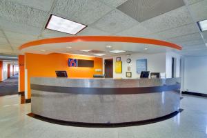 a lobby with a waiting area in a building at Motel 6 Dallas - Fair Park in Dallas