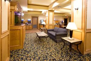 a hotel lobby with a couch and a television at Holiday Inn Express & Suites - Jourdanton-Pleasanton, an IHG Hotel in Jourdanton