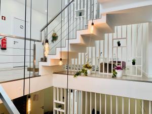 a staircase in a house with glass walls at Urban Apart - Azores in Ponta Delgada