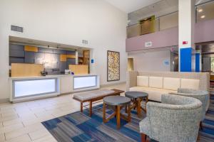 a lobby with a waiting area with chairs and a couch at Holiday Inn Express Phoenix-Airport/University Drive, an IHG Hotel in Phoenix