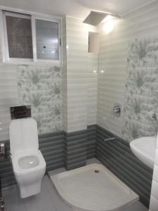 a bathroom with a toilet and a sink at RAJHAT MARANAO House in Bodh Gaya