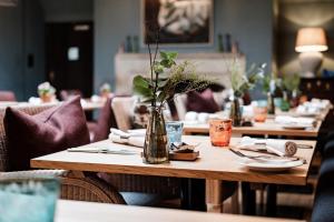 a wooden table with a vase of flowers on it at The Lamb Inn in Burford