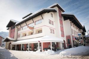 a large building with snow in front of it at Biohotel Garmischer Hof in Garmisch-Partenkirchen