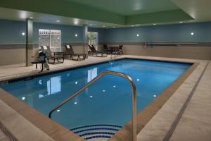 a large swimming pool in a hotel room at Holiday Inn Express & Suites - Portland Airport - Cascade Stn, an IHG Hotel in Portland