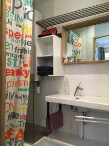 a bathroom with a sink and a mirror at Bulles Champagne Troyes Bouchon in Troyes +17 photos