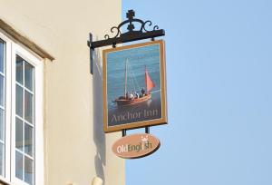 a clock on the side of a building at Anchor Inn by Greene King Inns in Beer
