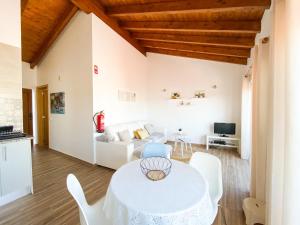 a living room with a white table and white chairs at Casa do Sapateiro - No centro histórico de Aljezur in Aljezur
