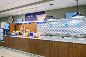a fast food restaurant counter with blue and white tiles at Holiday Inn Express & Suites - Atchison, an IHG Hotel in Atchison