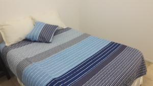 Postel nebo postele na pokoji v ubytování DPTO ALTA CORDOBA + 13 fotografií