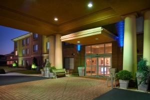 a building with a bench in front of it at Holiday Inn Express Hotel & Suites Anniston/Oxford by IHG in Oxford