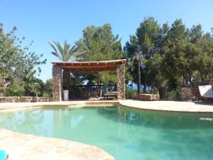 a swimming pool with a gazebo in a yard at Agroturismo Can Talaias San CArlos in Sant Carles de Peralta