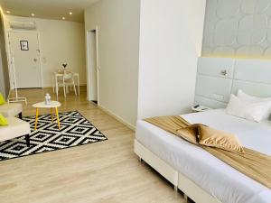 a bedroom with a bed and a chair and a table at Urban Apart - Azores in Ponta Delgada