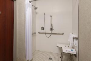 a white bathroom with a shower and a sink at Holiday Inn Express Independence - Kansas City, an IHG Hotel in Independence