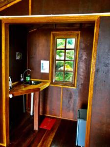 a kitchen with a sink and a window at Beachfront Hut Upstairs Astra - Beach Shack Chalet in Tioman Island